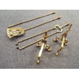 A brass fireside companion set and a pair of fireside dogs