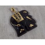 A 14ct gold and onyx pendant in the form of a elephant