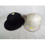 A gentleman's Falcon bowler hat, marked The Aintree Special Fitting and a leather and cork helmet,