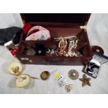 A jewellery box containing a large quantity of costume jewellery to include a Florenza brooch,