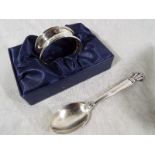 A silver coffee spoon by Georg Jenson and a hallmarked silver napkin ring,