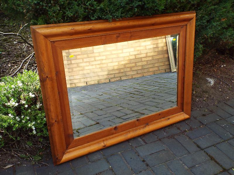 A good quality large oak framed bevel edged wall mirror,