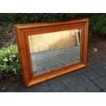 A good quality large oak framed bevel edged wall mirror,