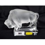 A Lalique glass figurine depicting a buffalo inscribed to the base Lalique France 10cm (h)