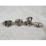 Four white metal fashion rings depicting skull,