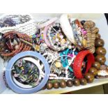 A large quantity of costume jewellery to include micro beaded necklaces, graduated treen necklaces,