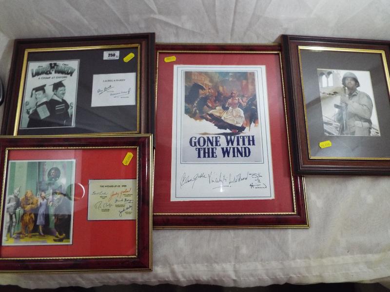 A collection of four movie and TV prints with signatures