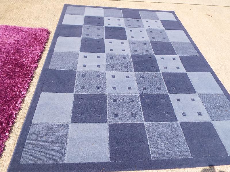 Two rugs, one with blue check, approx size 170cm x 230cm and another purple, - Image 2 of 3