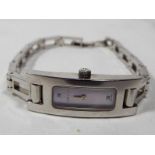 A lady's designer Gucci wristwatch with white metal strap,