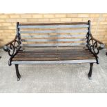 A cast iron garden bench with wooden slats 78cm x 128cm x 66cm