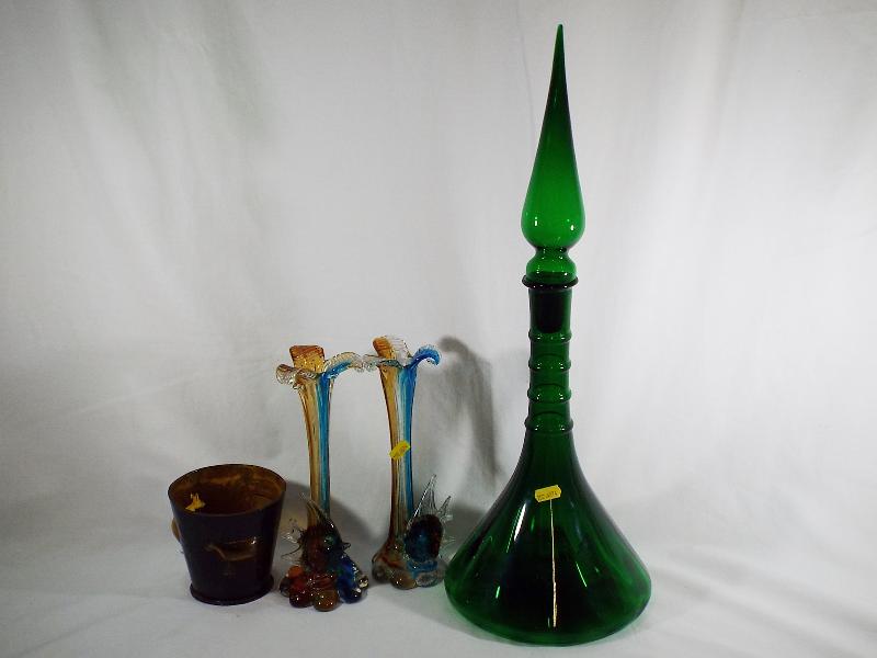 A large green ornamental apothecary style bottle with spike stopper,