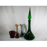 A large green ornamental apothecary style bottle with spike stopper,