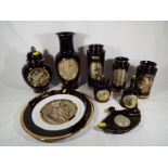 A large collection of Japanese black Chokin pottery decorated with birds, 24k gold edge,
