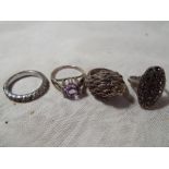 Three silver dress rings and one white metal (4)