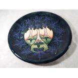 A Moorcroft Pottery large plaque / plate decorated in a modern foliate design,