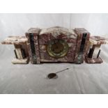 An Art Deco styled clock set in pink and white veined marble and green marble accents,