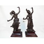 A pair of Asian bronze figures mounted on wooden plinths,