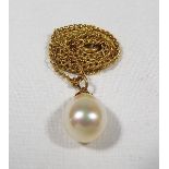 A lady's pearl pendant with 9ct gold mount, on a yellow metal chain, approximate 3.