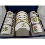 A Royal Worcester set of six coffee cans and saucers decorated in the Columbine pattern,