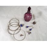 A collection of silver and white metal jewellery and a cut to clear perfume bottle