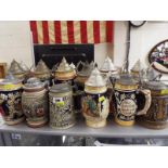 A large collection of approximately 18 ceramic steins