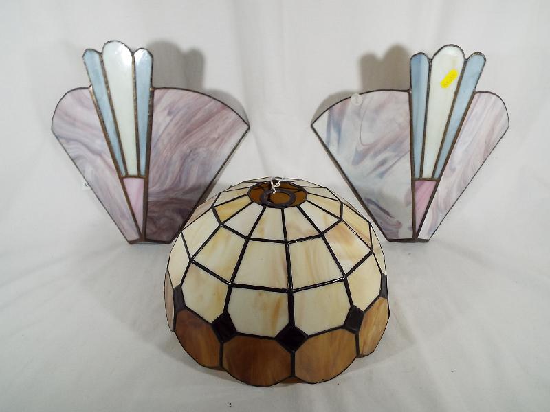 A pair of Tiffany style wall lights and a Tiffany style lamp shade