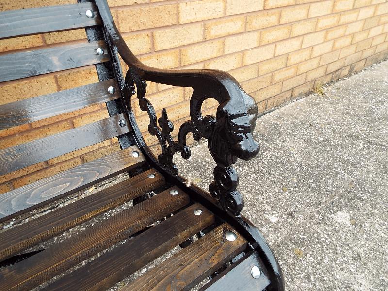A cast iron garden bench with lion head and wooden slats 77cm x 126cm x 66cm - Image 2 of 2