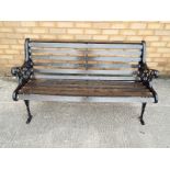 A cast iron garden bench with wooden slats 73cm x 127cm x 58cm