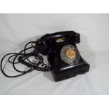 A GPO 332L Bakelite telephone with drawer and chrome number dial