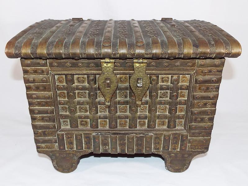 A good quality lidded chest with applied brass panelling, twin handles,