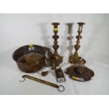 A collection of brass ware to include an inkwell, candlesticks,