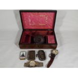 An wooden box containing a plated vesta case,
