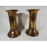 A pair of brass trench art cylindrical vases with flared tops, the base 22.