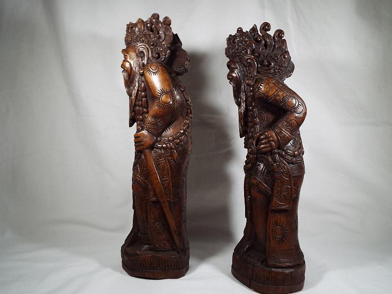 A pair of Oriental figural carvings depicting Chinese characters, 35. - Image 2 of 3