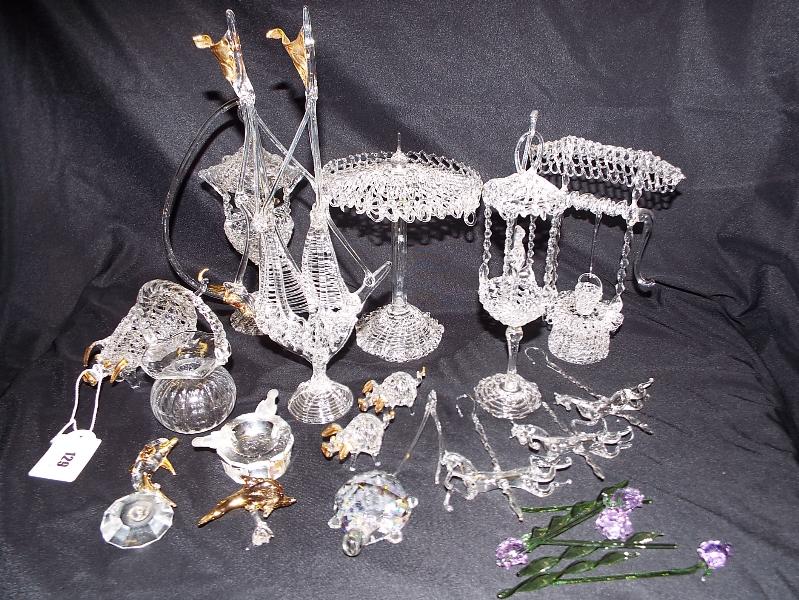 A collection of blown glass ware depicting animals, bird cage,