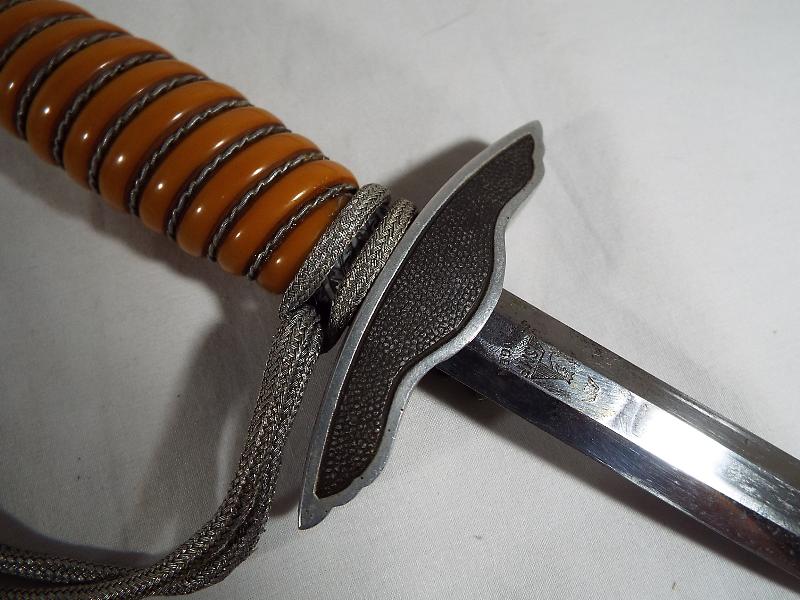 A Third Reich German Luftwaffe dagger with woven white metal wire bound orange celluloid grip, - Image 7 of 9