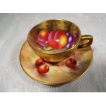 A Royal Worcester cup and saucer set hand painted with fallen fruits, the cup signed H Ayrton,