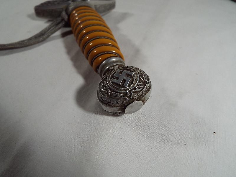 A Third Reich German Luftwaffe dagger with woven white metal wire bound orange celluloid grip, - Image 6 of 9