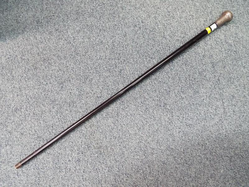 A gentleman's ebony walking cane with silver hallmarked bulbous top,