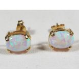 A lady's pair of 9ct gold stud earrings set with opals