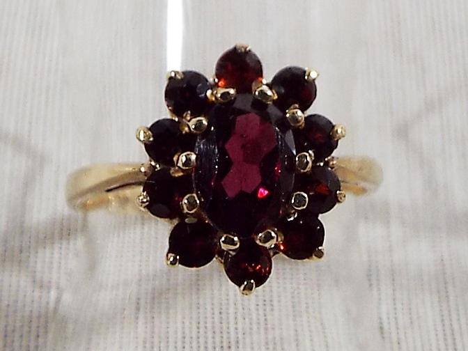 A lady's hallmarked 9ct yellow gold garnet cluster ring, approx weight 2.