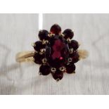A lady's hallmarked 9ct yellow gold garnet cluster ring, approx weight 2.