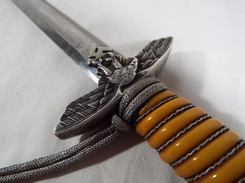 A Third Reich German Luftwaffe dagger with woven white metal wire bound orange celluloid grip, - Image 4 of 9