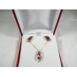 A lady's pair of 9ct gold earrings set with amethyst and diamond, with matching pendant,