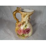 A Royal Worcester blush ivory jug with coral moulded handle, floral decoration with gilded accents,