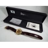 A gentleman's Stauer 1779 skeleton watch, brown leather strap,