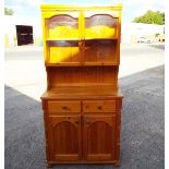 A pine dresser with glazed doors above two drawer over two door opening,