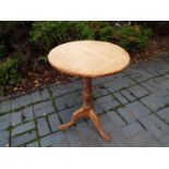 A period oak circular-topped table, the stem on tripod supports,