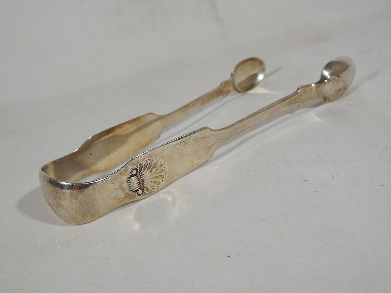 A pair of Victorian silver hallmarked sugar tongs, Newcastle assay,
