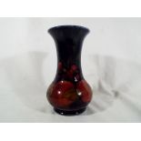 A Moorcroft Pottery large trumpet vase decorated in the Pomegranate patter, signed to the base,